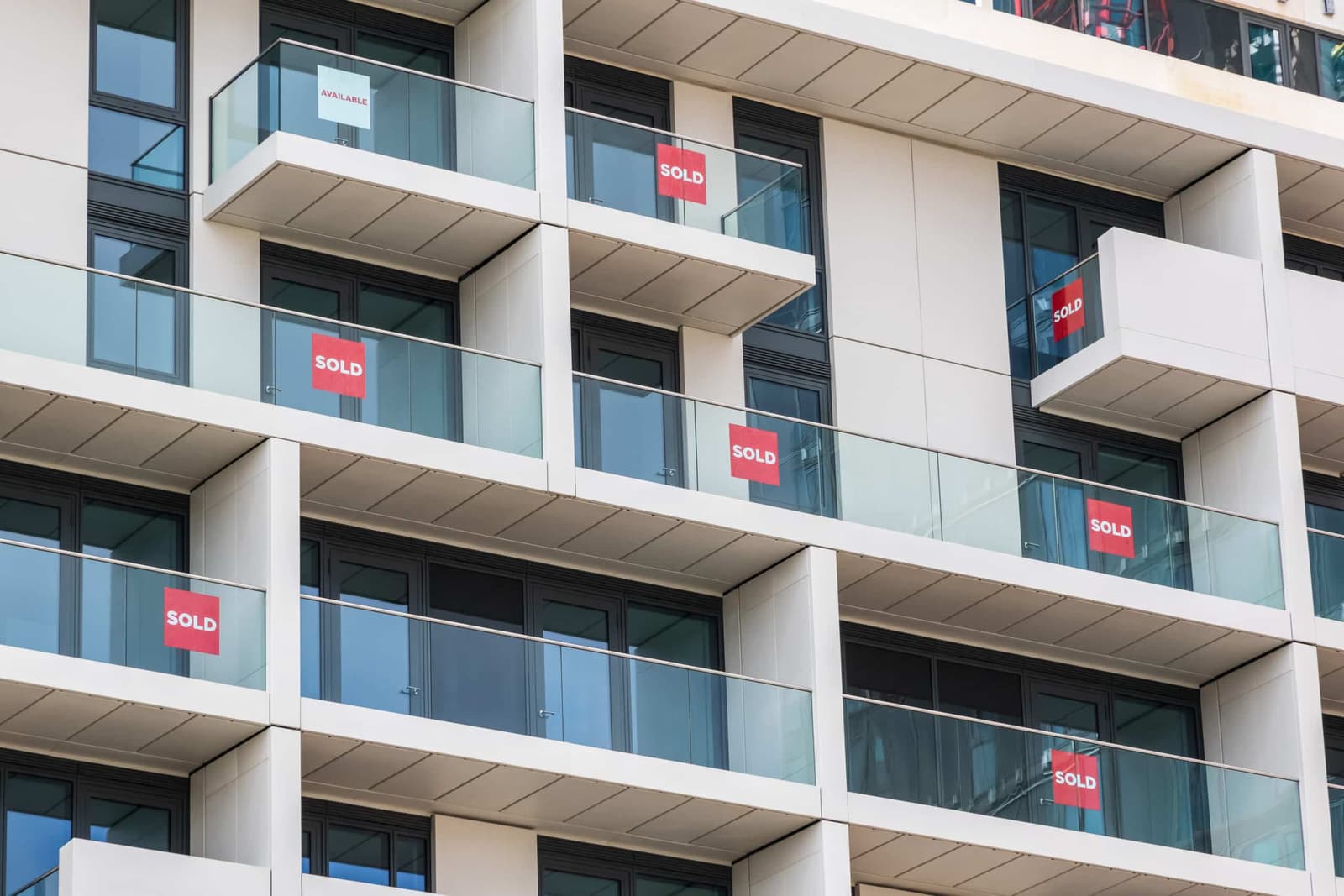 Apartment block balconies with sold signs in the windows