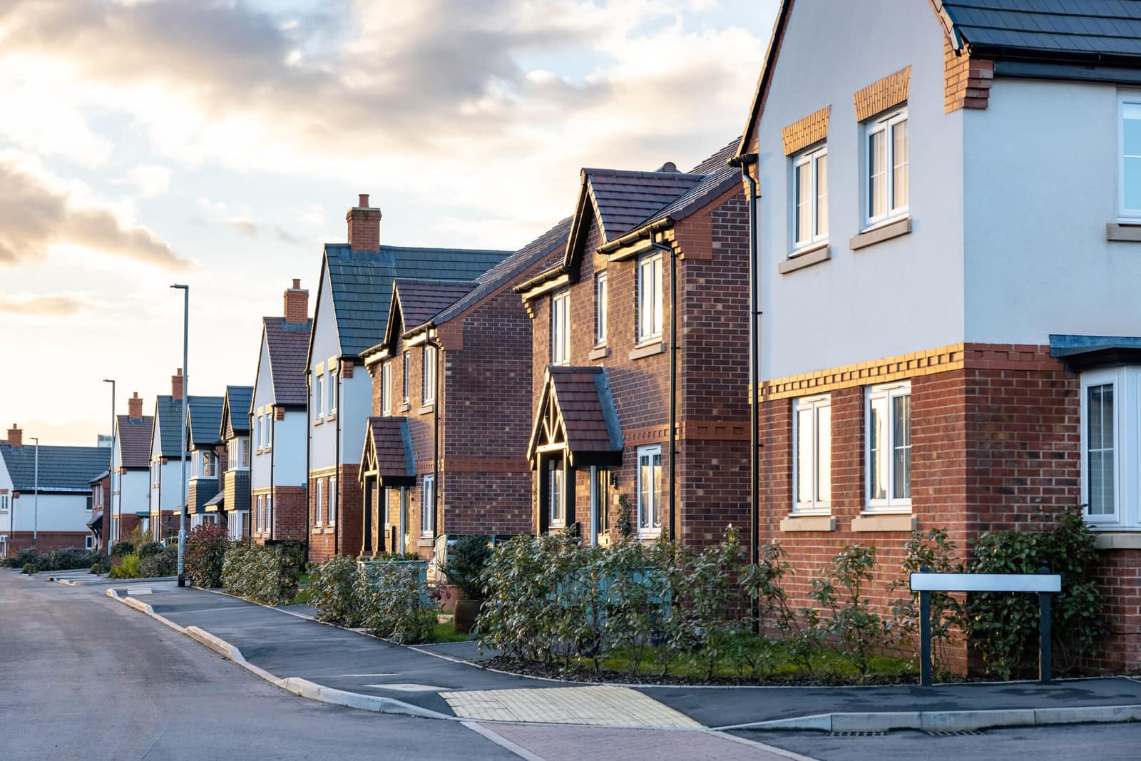 Street of new build brick houses at dusk