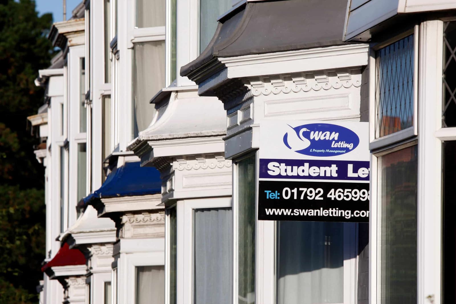 Student letting agency sign fixed to a white Georgian townhouse